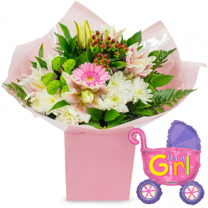 A celebratory new baby girl floral gift is beautifully arranged against a clean white background, evoking the bright, open feel of riverside homes along Isle of Dogs. At the centre of the image is a generous, florist-designed bouquet emerging from a sturdy, square, light pink gift box. The box itself stands tall and elegant, its soft pastel tone mirrored in the layers of ballet-pink tissue paper that billow gently around the stems. A clear veil of cellophane catches the light, suggesting the crisp freshness of flowers prepared for same-day delivery. Dominating the centre of the bouquet is a single bright pink gerbera daisy, its flat, daisy-like face acting as a joyful focal point. Surrounding it, clusters of snowy white chrysanthemums gather like tiny pom-poms, their dense petals providing both softness and volume. Delicate Alstroemeria lilies, white with blush-pink streaks and fine speckles, weave between the other blooms, some partly open, others still held in pale yellow buds that speak of unfolding moments ahead with a newborn daughter. Vivid lime-green button flowers and spires of fresh foliage offer lively contrast, while deep red Hypericum berries peep through the greenery, adding a sophisticated hint of warmth. Dark, glossy leaves and light, feathery fern fronds frame the arrangement, giving it a lush and abundant silhouette ideal for placing on a nursery chest of drawers or dining table in a Docklands apartment. To the right of the flowers floats a foil balloon shaped like a baby stroller, its metallic surface gleaming in hot pink with a contrasting purple hood and wheels. The wheels themselves feature colourful spokes, and across the body of the pram, jaunty yellow and green letters spell out It's a Girl!, embellished with tiny heart details. The whole ensemble radiates pure happiness and welcome, capturing the sweetness, excitement, and sense of new beginnings that surround a baby girl's arrival on the Isle of Dogs.